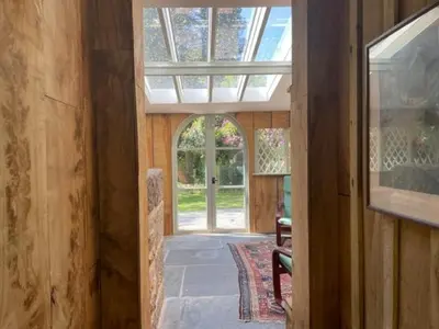 a hallway with an open door to a house at Wodehouse in Falmouth