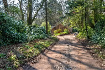 a dirt road with a house in the distance at Wodehouse in Falmouth
