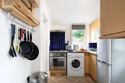 a kitchen with a washer and dryer in it at Little Haven in Falmouth