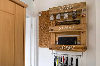 a kitchen with a wood spice rack on the wall at Little Haven in Falmouth