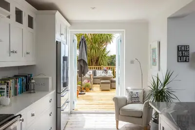 a kitchen with a door leading to a patio at Trewartha in Penzance