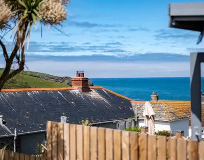 a view of the ocean from a house with a fence at Mino Cottage in Port Isaac