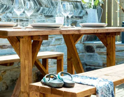 a wooden table with two pairs of slippers on it at Mino Cottage in Port Isaac
