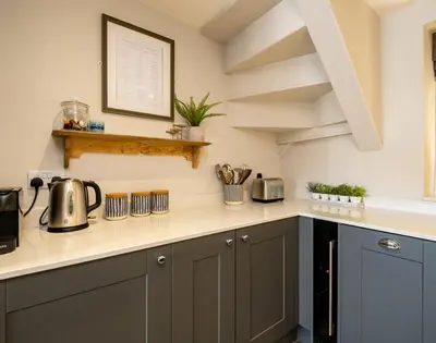 a kitchen with a counter top with pots and pans at Mino Cottage in Port Isaac