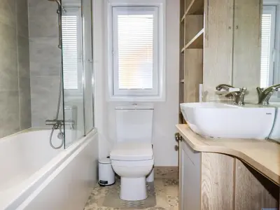 a bathroom with a white toilet and a sink at Beachcliff in Newquay