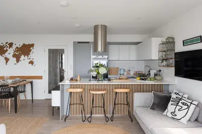 a kitchen and living room with a couch and a table at Ocean View, The Sands in Praa Sands