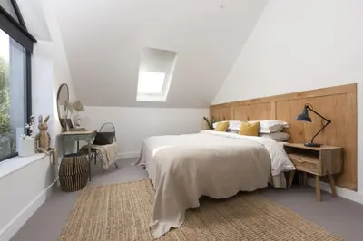 a bedroom with a large bed and a window at Ocean View, The Sands in Praa Sands
