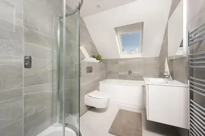 a bathroom with a toilet and a sink and a shower at Ocean View, The Sands in Praa Sands
