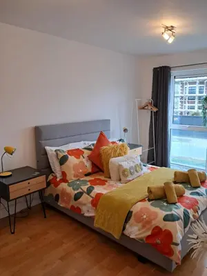 a bedroom with a bed and a window at Fistral beach apartment in Newquay