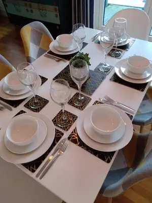a table with plates and wine glasses on it at Fistral beach apartment in Newquay