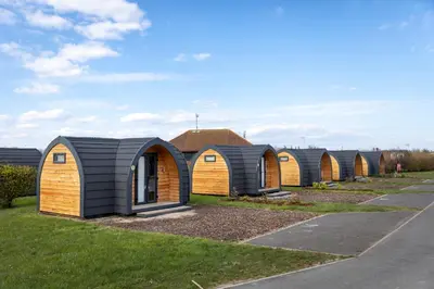 a row of tiny houses lined up in a row at Camping Pods Trevella Holiday Park in Crantock
