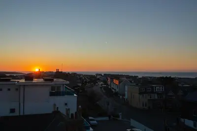 a view of a sunset from a building at Trevose Penthouse in Newquay