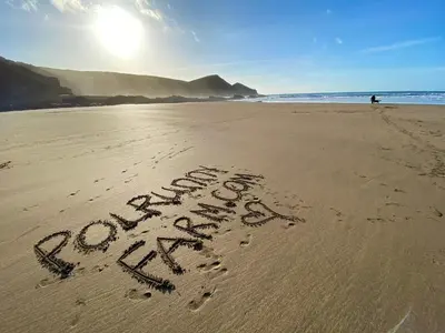 a word written in the sand on a beach at Polrunny Farm Seaberry Cottage with a sea view and log burner in Boscastle