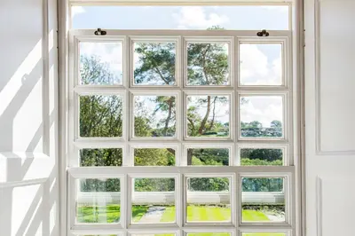 an open window with a view of trees at Cusgarne Manor boutique B&B - adults only in Cusgarne