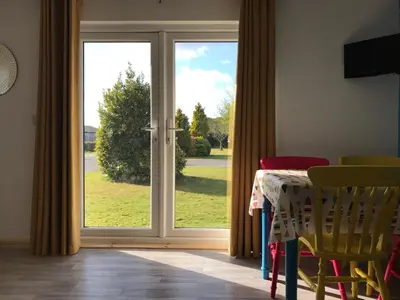 a sliding glass door with a view of a yard at Kingfisher Glamping Cabin in Bodmin