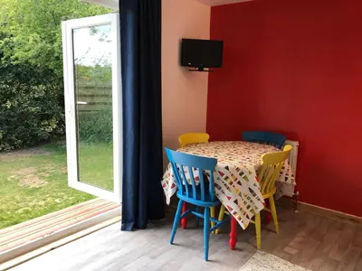 a table and chairs in a room with a window at Woodpecker Glamping Cabin in Bodmin