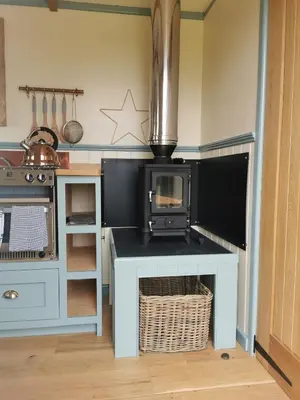a kitchen with a counter with a microwave on it at Toms Hut and Robins Rest Shepherd Huts near Wadebridge in Wadebridge