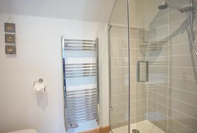a bathroom with a shower stall and a toilet at Seawynds in Port Isaac
