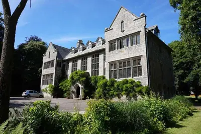 a large white building with a car parked in front of it at Hengar Manor Apartments in Michaelstow