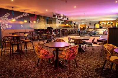 a restaurant with tables and chairs and a bar at Hengar Manor Apartments in Michaelstow