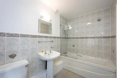 a bathroom with a sink and a tub and a toilet at Hengar Manor Apartments in Michaelstow