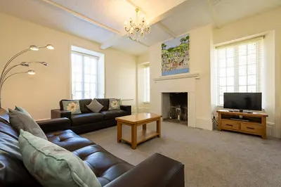 a living room with a couch and a television at Hengar Manor Apartments in Michaelstow
