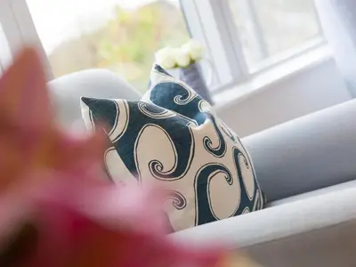 a pillow sitting on a couch next to a window at The Lighthouse in St Ives