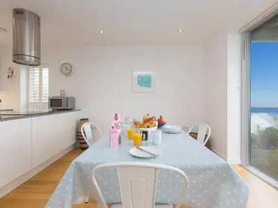 a dining room table with a blue polka dot table cloth at The Lighthouse in St Ives
