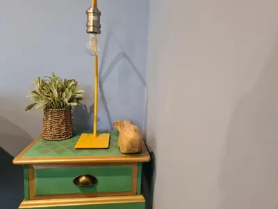 a table with a lamp and a plant on it at Pebble Cottage in Uny Lelant