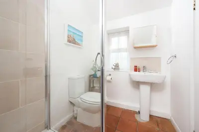 a bathroom with a toilet and a sink and a shower at Laity Vean Hideaway - 2 Pets Allowed - Free Parking & WiFi in Carbis Bay