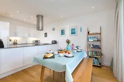 a kitchen with a table with food on it at Puffins in St Ives