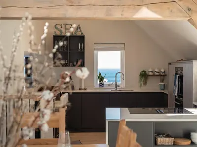 a kitchen with a sink and a counter with a window at Church Rooms in Port Isaac