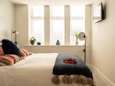 a bedroom with a bed with a teddy bear on it at Church Rooms in Port Isaac