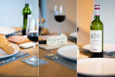 a table with a bottle of wine and glasses of wine at Porthminster Mews in St Ives