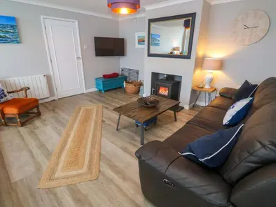 a living room with a couch and a table at Stonecroft in Praa Sands