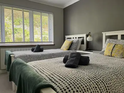 a bedroom with two beds with pillows on them at Stonecroft in Praa Sands