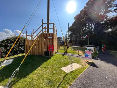 a park with a playground with a swing at Contemporary Caravan at Newquay Holiday Park in Newquay