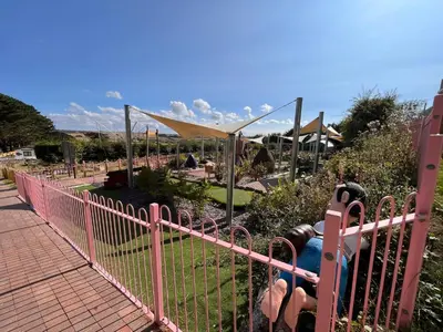 a pink fence in front of a park at Contemporary Caravan at Newquay Holiday Park in Newquay