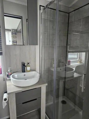 a bathroom with a sink and a glass shower at Mawgan Pads Padstow in Padstow