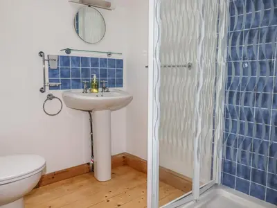 a bathroom with a sink and a shower at Little Orchard Barn in St Austell