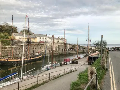 a group of boats docked in a harbor at Wheal ProsperThe West Dry in St Austell