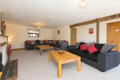 a living room with two couches and a table at The KilnsThe West Dry in St Austell