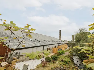 a building with solar panels on the side of it at The LinneyThe West Dry in St Austell