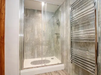 a shower with a glass door in a bathroom at RiversideThe West Dry in St Austell
