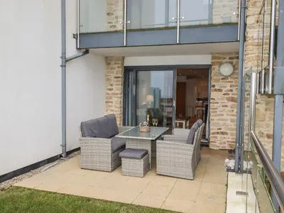 a patio with two chairs and a table at Sky in St Ives