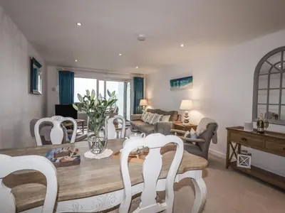 a living room with a table and chairs at Sky in St Ives