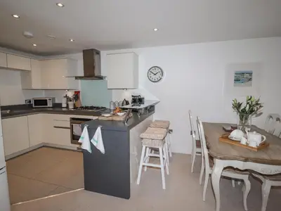 a kitchen with a table and a counter top at Sky in St Ives