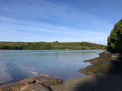a river with some rocks in the water at Amazing 2-bedroom apartment with lovely sea views in Newquay