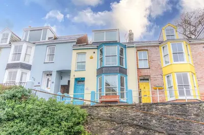 a row of colorful houses on a street at The Slipway Fowey Harbour Parking 1 Min & Garden in Fowey