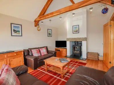 a living room with a couch and a table at Penlaurel in Bude
